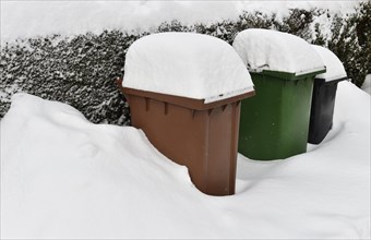 Snow-covered waste bin