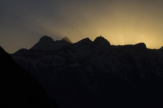 Kongde and other peaks of Rolwaling Himal backlit by the setting sun
