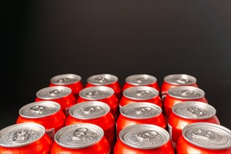 Group of fresh beer cans with drops of water with black background