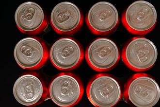 Group of fresh beer cans with drops of water with black background