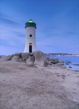 Lighthouse on the beach at blue hour