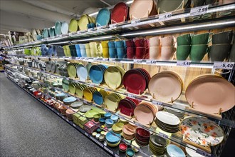 Shelf with colourful tableware in the wholesale market