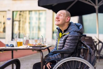 Portrait of a disabled person in a wheelchair in a restaurant