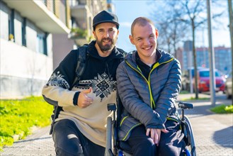 Portrait of a disabled person in a wheelchair with a friend