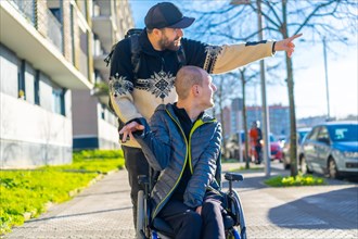 A person with a disability in a wheelchair with a friend walking around having fun
