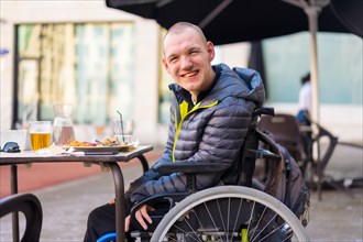 Portrait of a disabled person in a wheelchair in a restaurant
