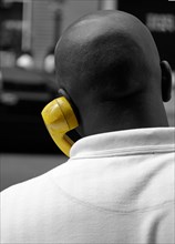 African American man talking on yellow phone