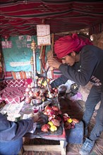 Jordanian Bedouin pressing fresh pomegranate juice in a tent