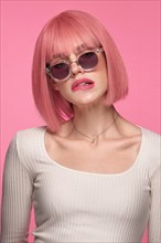 Beautiful funny cute woman in pink wig and classic makeup