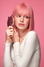 Beautiful funny cute woman in pink wig and classic makeup