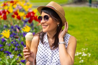 Tourist woman enjoying visiting the city eating a pistachio ice cream