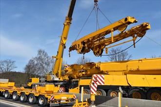 Truck-mounted crane and low loader on a construction site