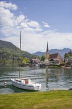 Church of St Laurentius and sailing boat with Tegernsee