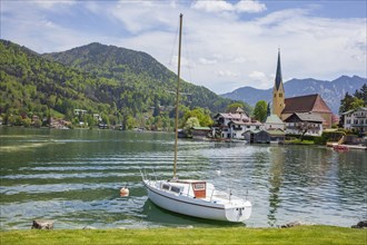 Church of St Laurentius and sailing boat with Tegernsee