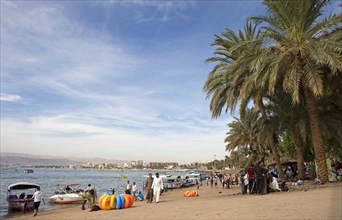 Jordanians and palm trees on the beach