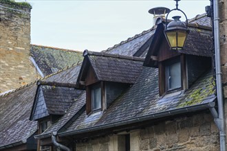 Dormer windows in the slate roof of a stone house