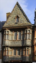 Half-timbered house clad in slate on the Place du General Leclerc