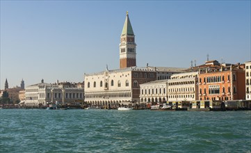 Doges palace and St Marco tower and other buildings on embankment from water