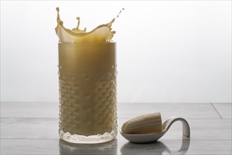 Banana smoothie with fresh fruit and cookie splash effect