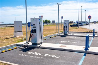 Electric car chargers at a gas station