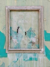 Weathered picture frame on a wooden wall