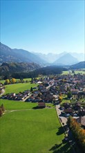 Aerial view of Fischen im Allgaeu with a view of the parish church of St Verena
