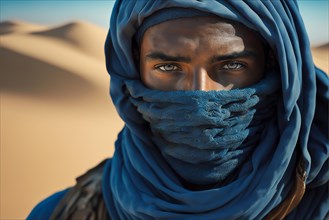 Photography closed shot portrait of berber gaze dressed in blue in the sand desert