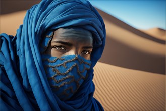 Photography closed shot portrait of berber gaze dressed in blue in the sand desert