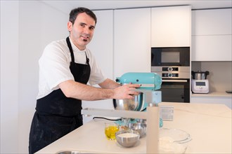 A man baker cooking a red velvet cake at home