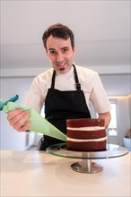 A challenger man bakes a red velvet cake at home