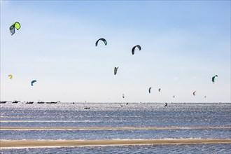 Group of kitesurfers kitesurfing in the Bay of Arcachon