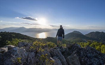 Hiker looking over volcanic peninsula Methana