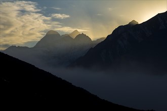 Looking down at sunset from a place above Dingboche in the upper Imja Khola valley of Khumbu Region of the Himalayas â€“ a mountain panorama with high peaks