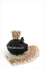 Piggy bank for black money and 50 euro banknotes