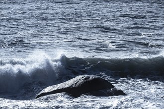 Waves between big rocks on the Mediterranean coast in Spain