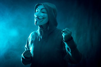 Hacker with anonymous mask with a making fight symbol