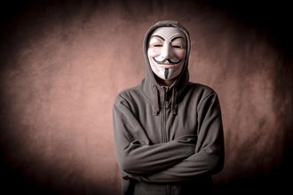 Man with anonymous mask with sweatshirt