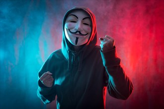 Hacker with anonymous mask with a symbol of fight