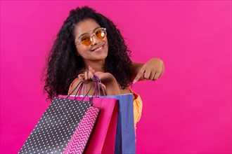 Curly-haired woman on a pink background