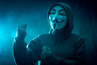 Hacker with anonymous mask with a making fight symbol