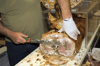 A man cuts a slice from a stuffed