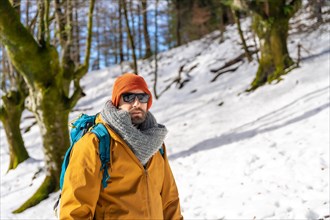 Portrait of a hiker with a backpack on a snow trekking