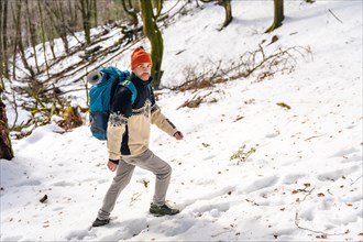 Hiker man on a trekking on the snow