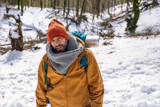 Portrait of a hiker with a backpack on a snow trekking