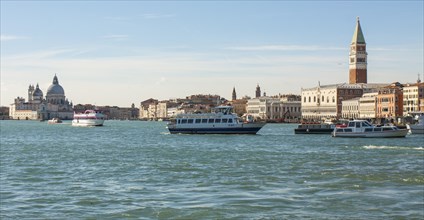Doges palace and St Marco tower and other buildings on embankment from water