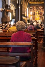 Faithful old lady in the church