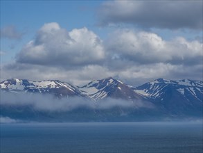 View over Eyjafoerour to the snow-capped mountains near Dalvik