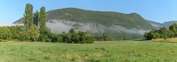 Panoramic landscape with rising mist in the valley in the morning