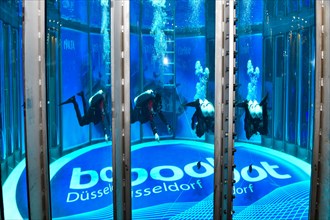 Diver in new diving tower in exhibition hall of water sports fair boot