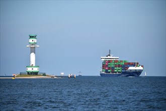 Buelk lighthouse and container ship in the Kiel Fjord